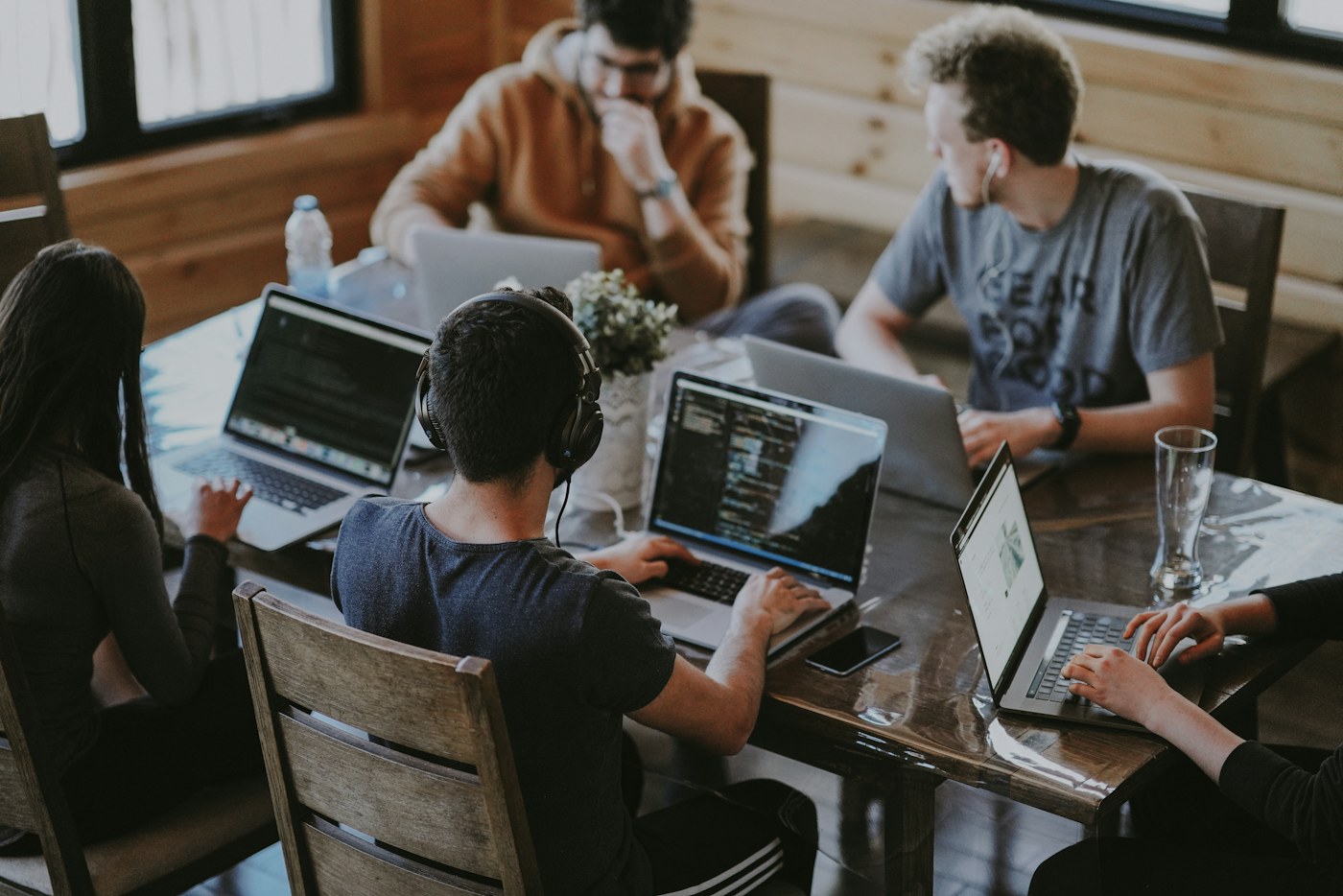Colleagues collaborating around a laptop in an office