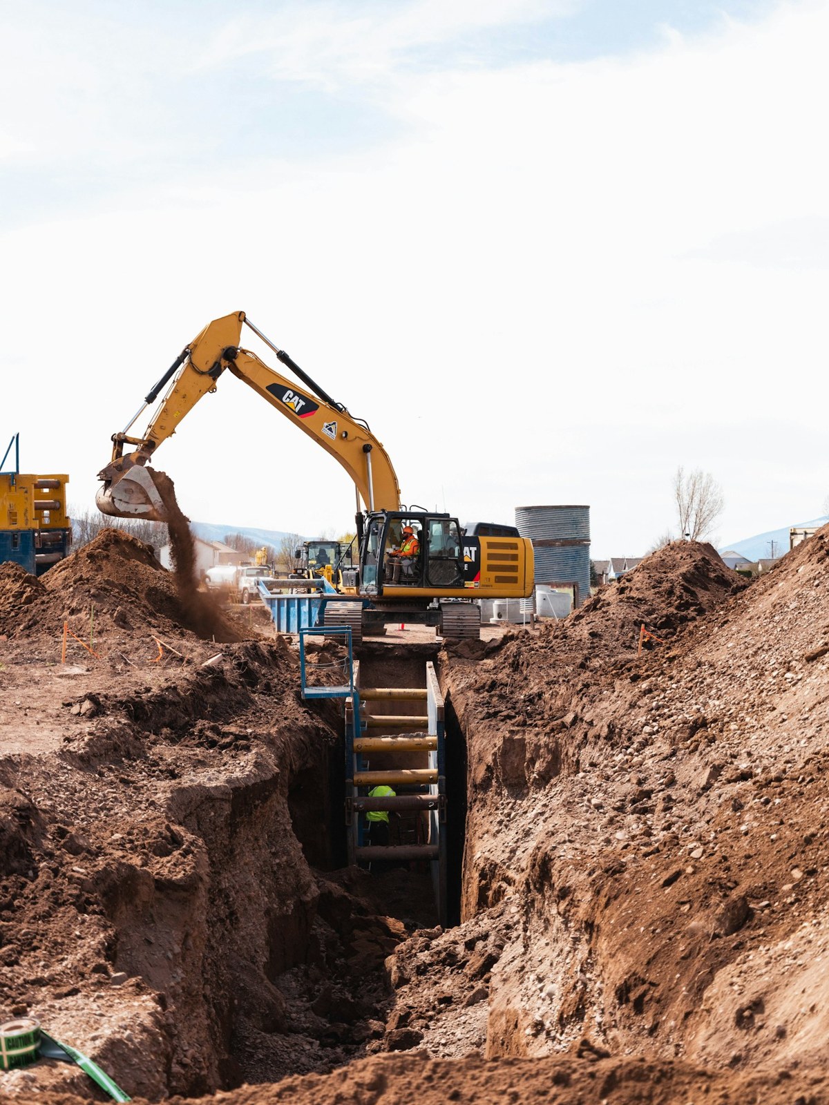 Excavator and worker on an active construction site