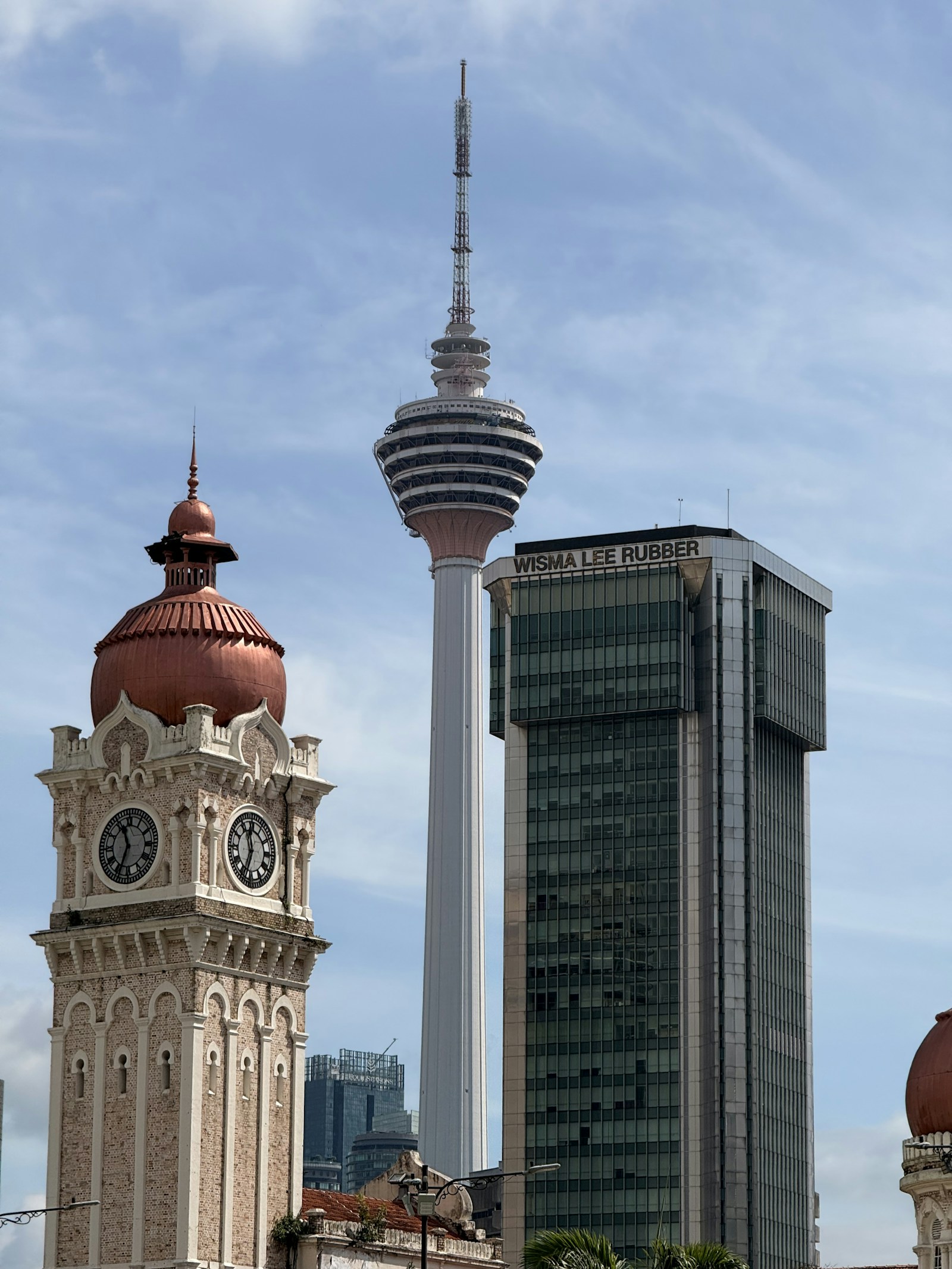 Historic clock tower, KL Tower and commercial buildings in Kuala Lumpur