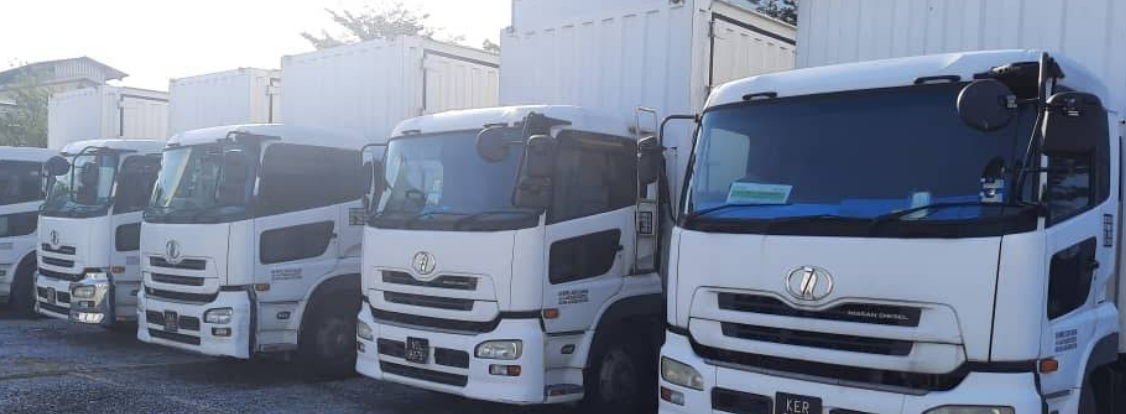 A wide view of a line of white commercial trucks